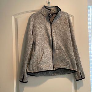 Heather grey, full zip, with black trim detail. Worn, good condition, no stains